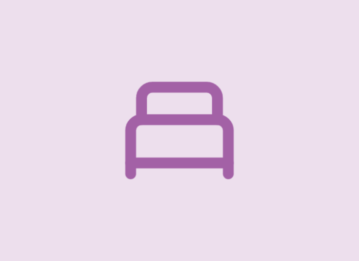 Simple purple bed icon on a pale lavender background, representing sleeping or a bedroom
