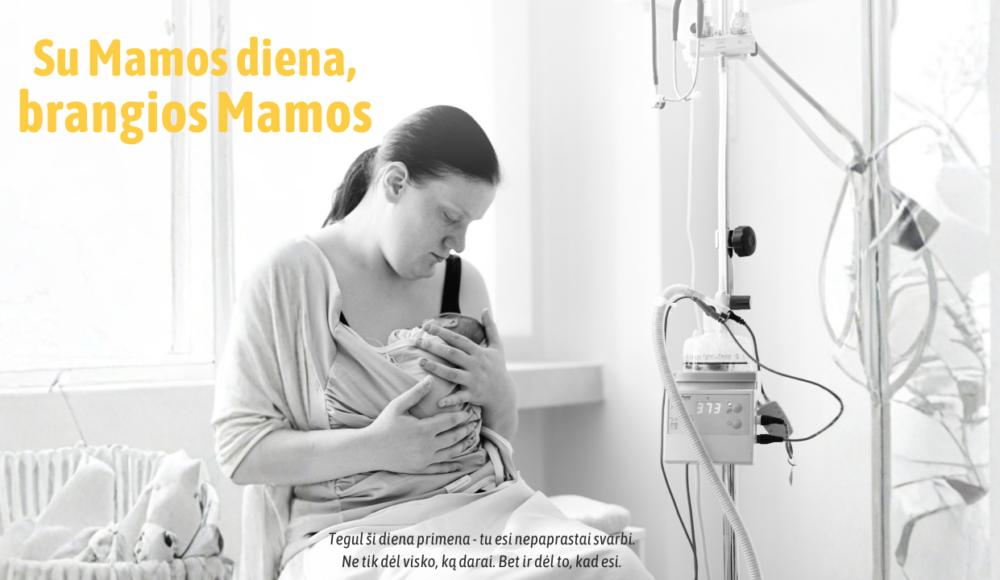 A mother cradles her newborn in a hospital room, with an IV pole nearby, overlaid with a Lithuanian Mother's Day banner.