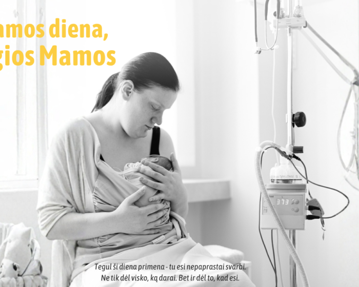 A mother cradles her newborn in a hospital room, with an IV pole nearby, overlaid with a Lithuanian Mother's Day banner.
