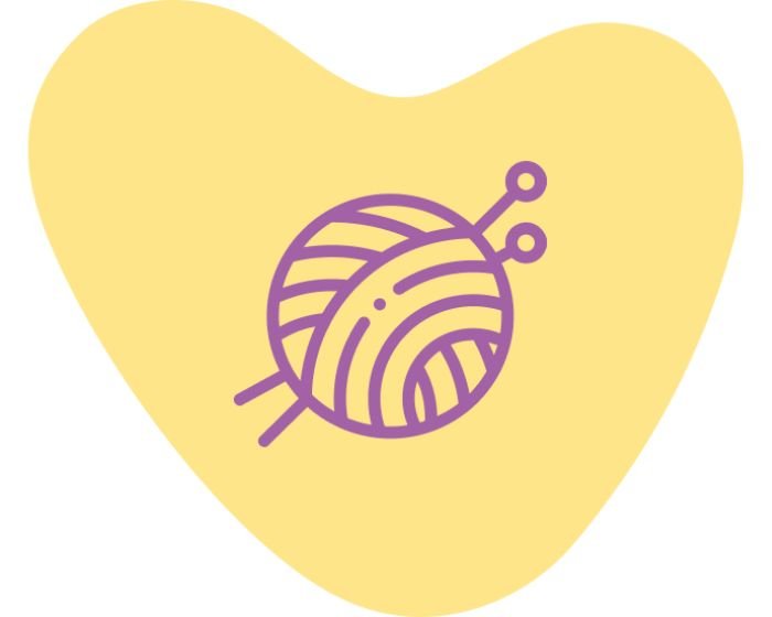 Purple yarn ball on a yellow heart-shaped background, symbolizing knitting or love of craftsually knitted items.